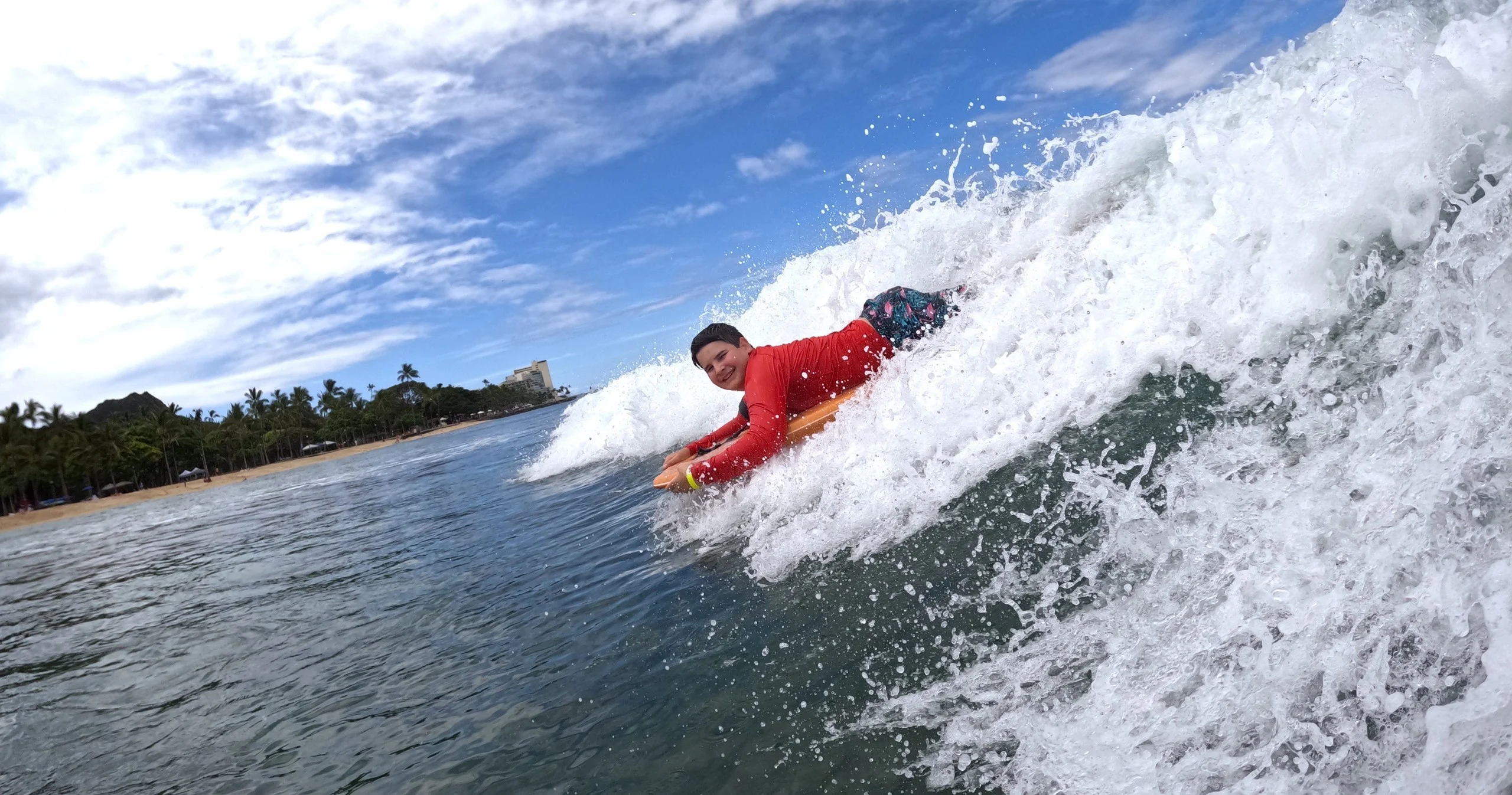 Surf lesson group with soft-top boards on a beach in Hawaii